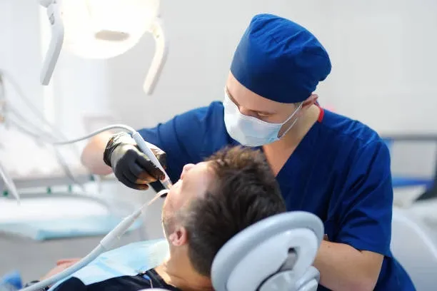 Dentist treating a patient at the clinic