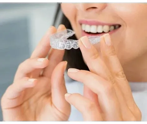 Patient holding a clear aligner