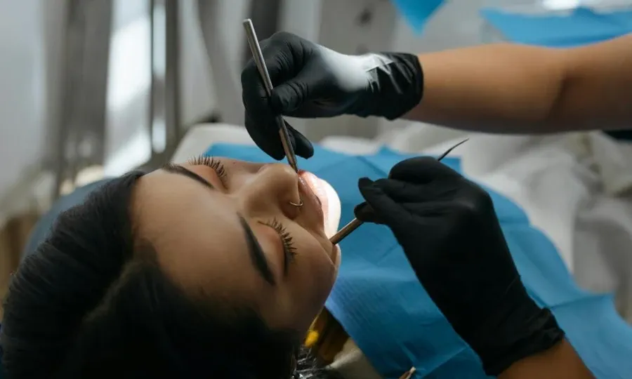 Dentist performing oral surgery
